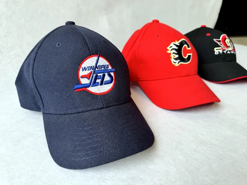 Three team caps with raised front embroidery